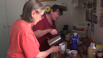 Family member and Support Worker in kitchen